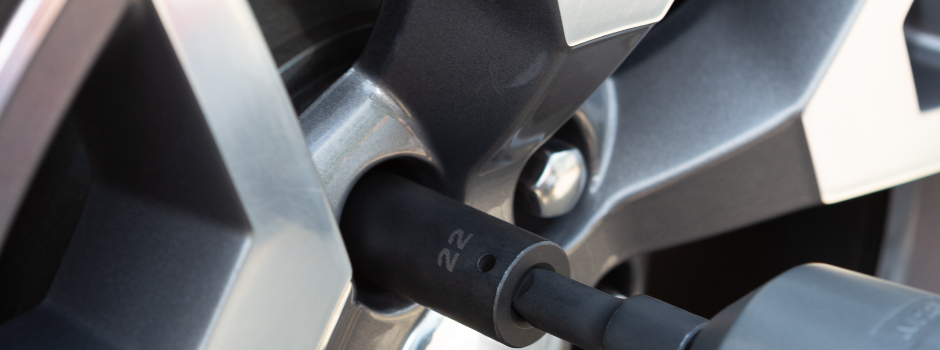 car tire being removed with a wheel socket